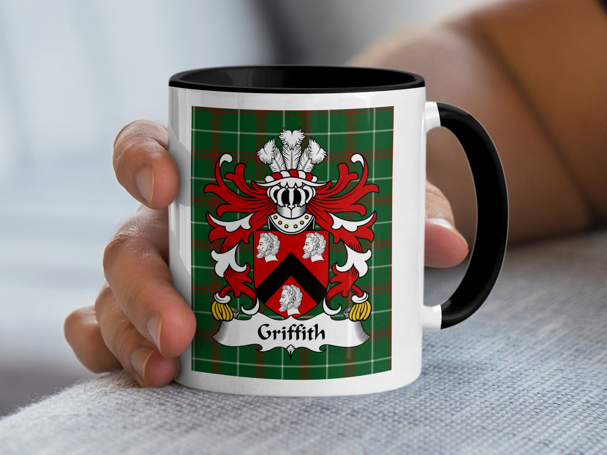 White mug with black handle, featuring the Griffith family crest on a green tartan pattern.