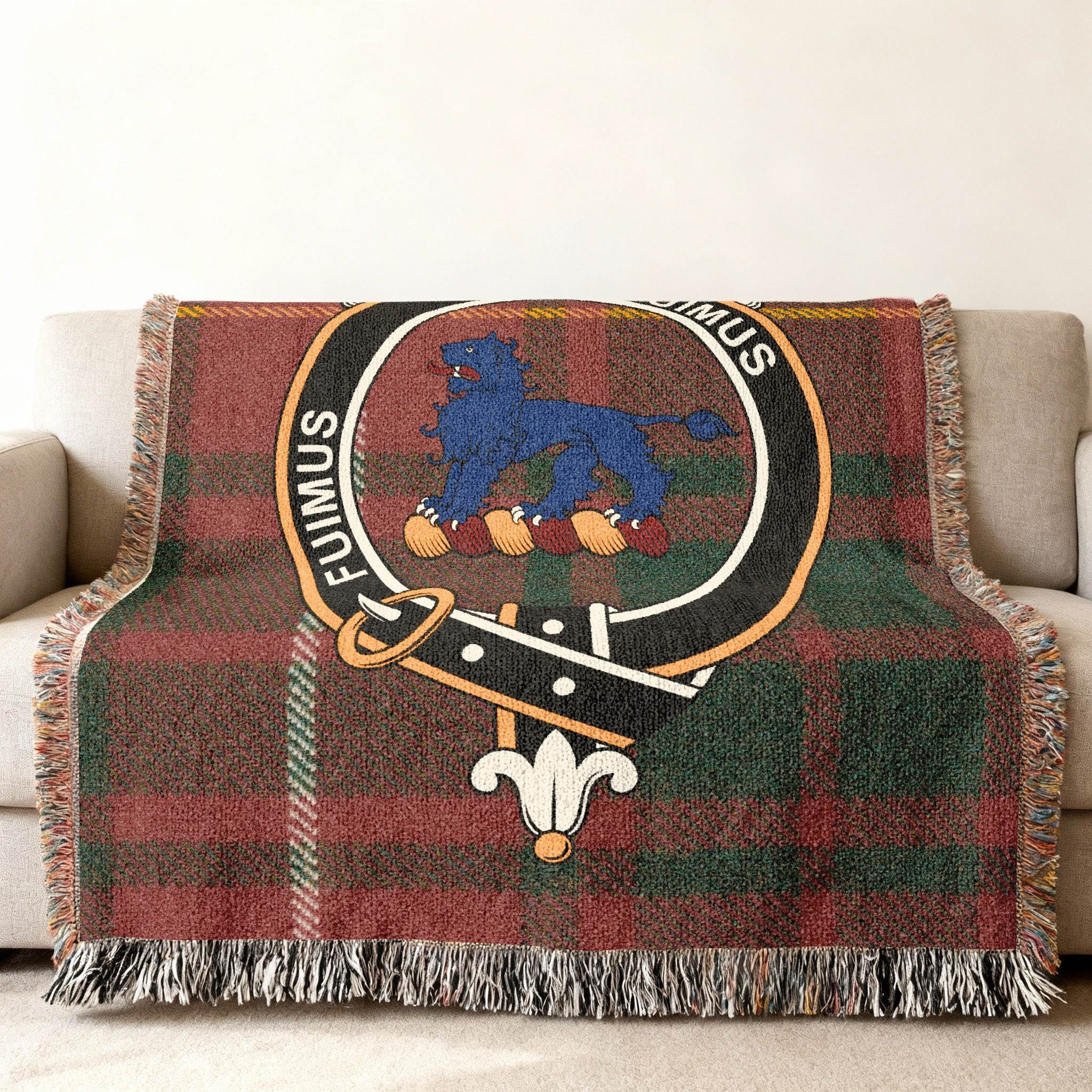 Bruce tartan woven blanket draped over armchair — fringe edges and Fuimus crest detail