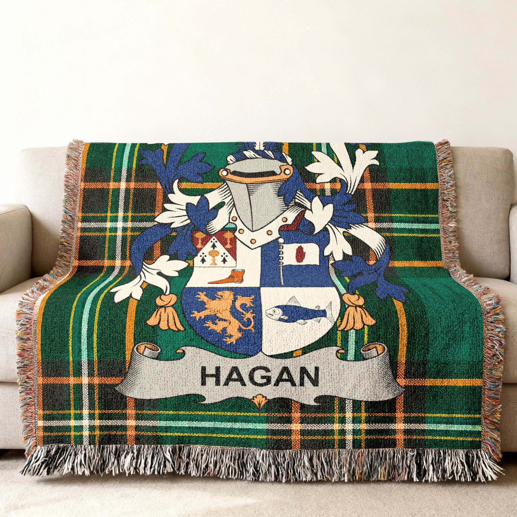 Tartan blanket featuring the Hagan family crest with a lion and fish.