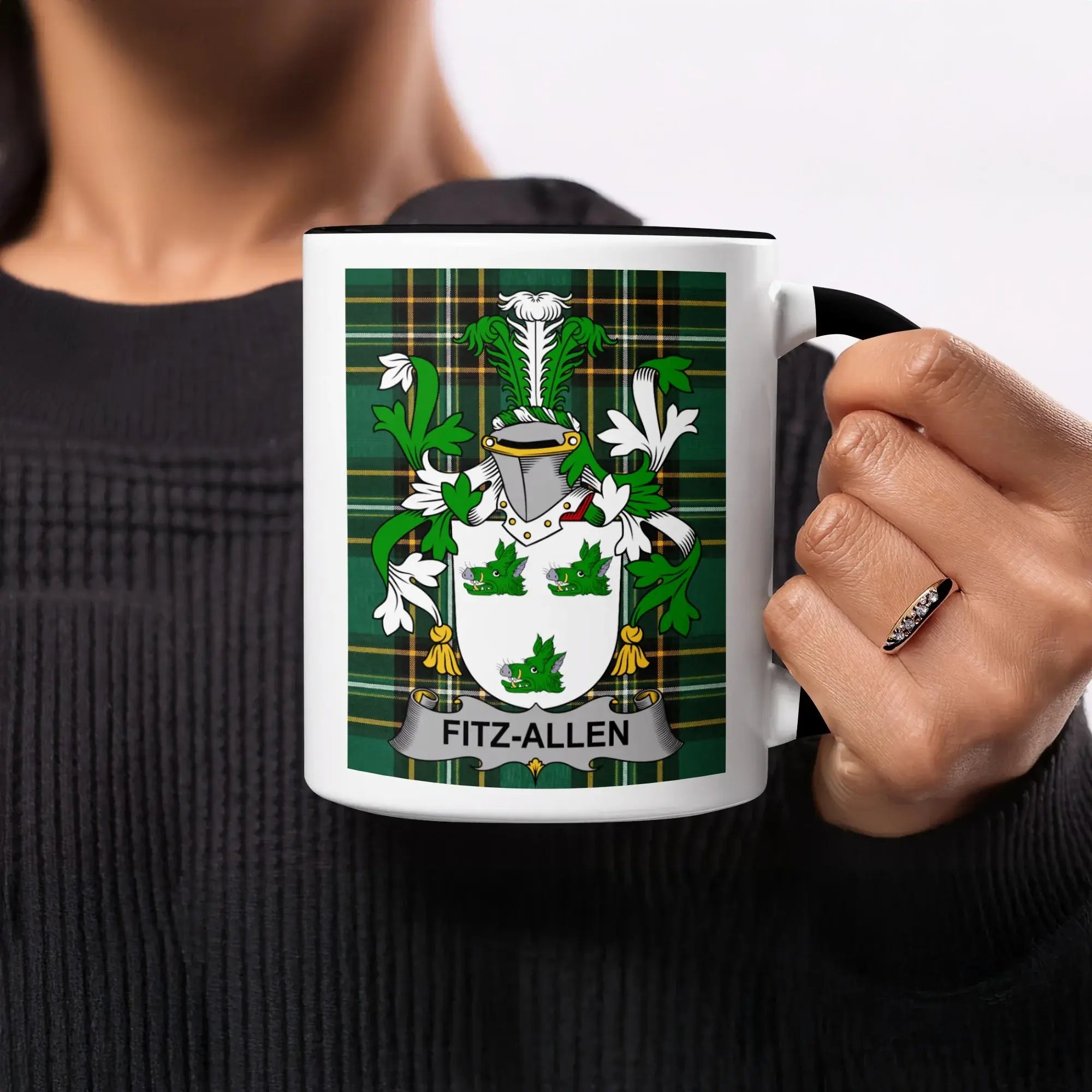 Fitz-Allen family crest on a white mug with black rim, held by a person.