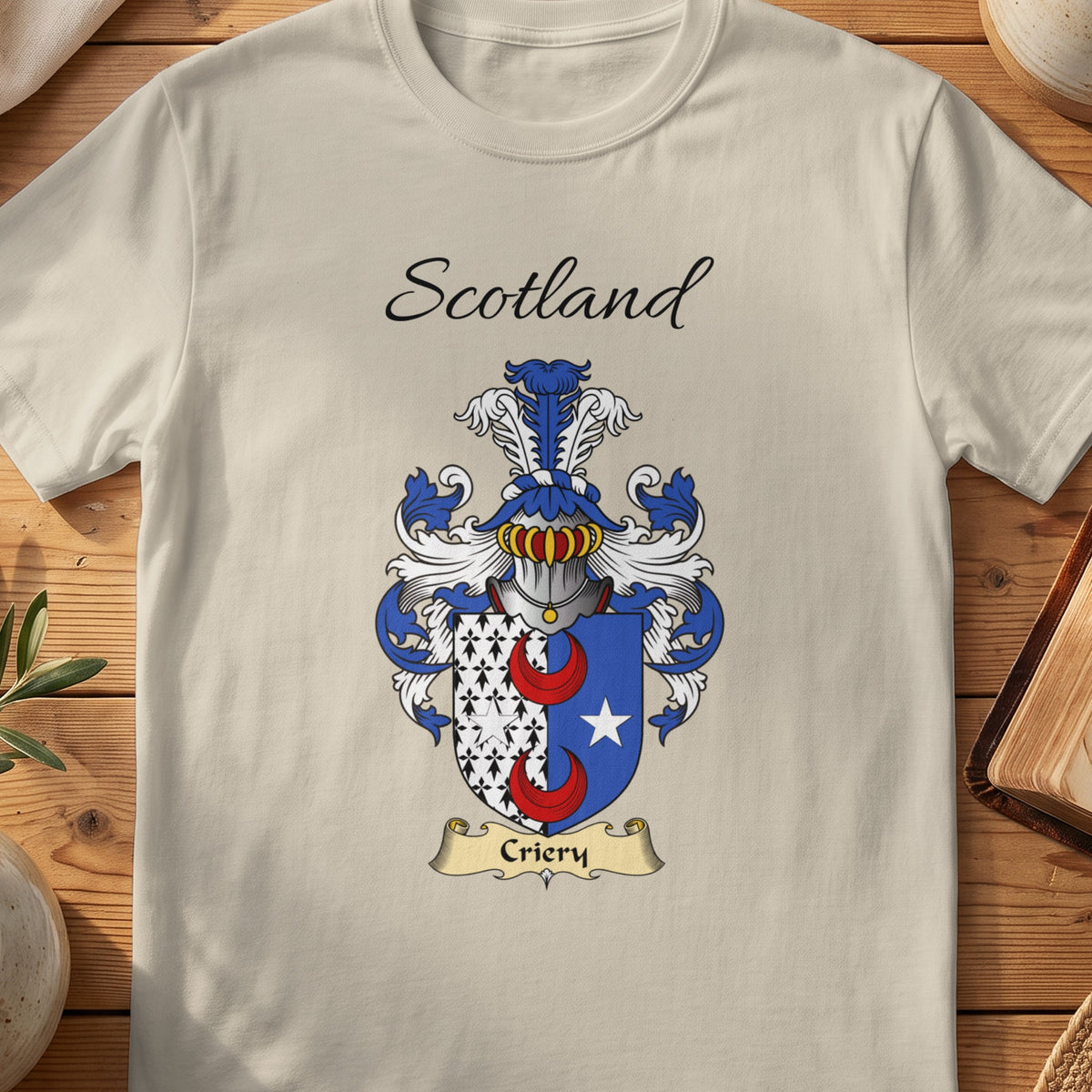 Sand Criery Scottish family shield T-shirt featuring red crescents beside a white patterned panel