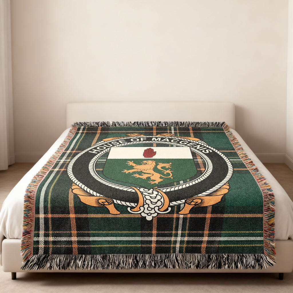 MacGenis family crest emblem woven blanket displayed on a bed