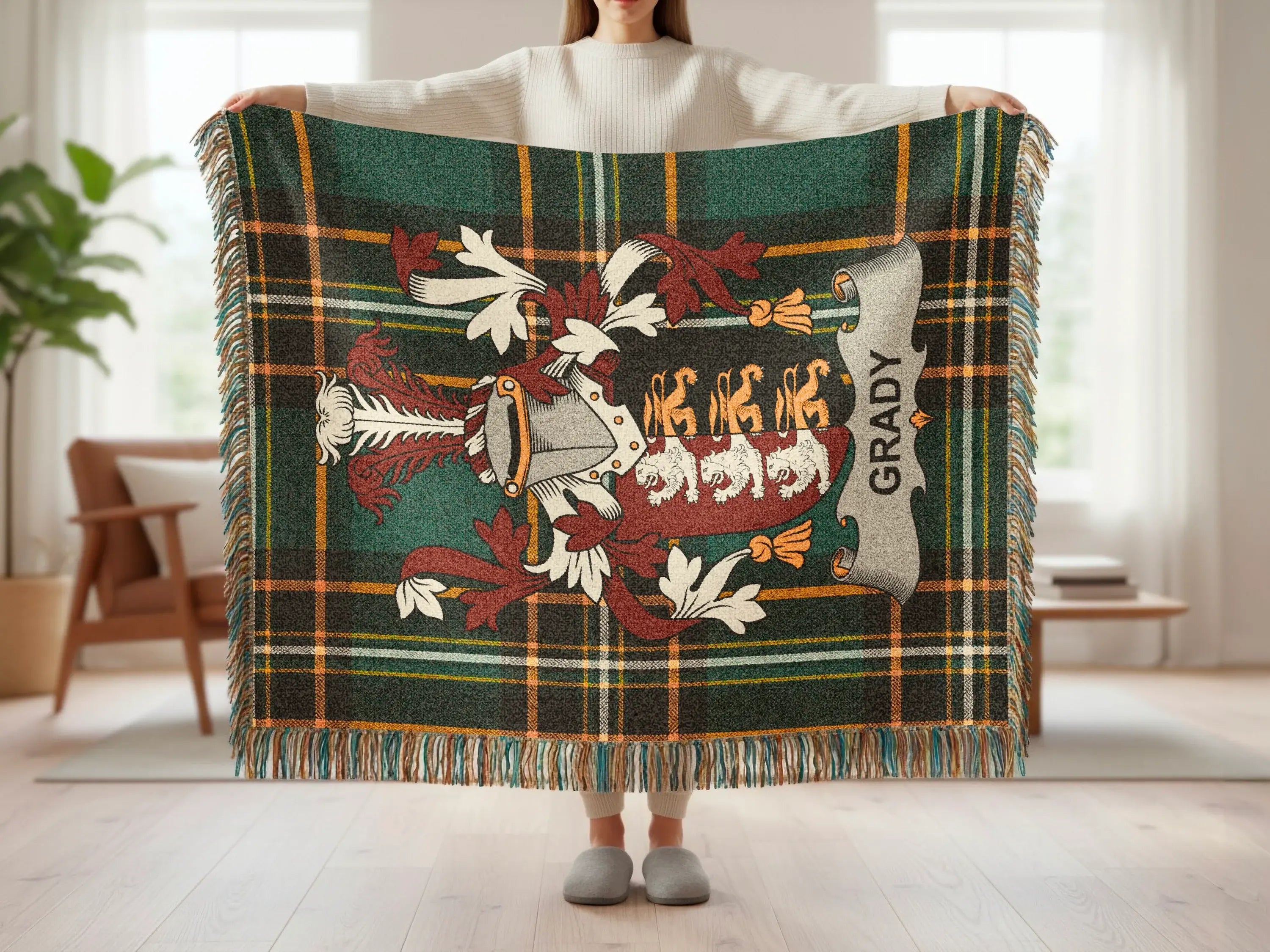Tartan blanket with Grady coat of arms held by person.