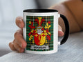 White mug with black rim and handle, featuring a tartan pattern and a coat of arms with the name BRANIGAN.