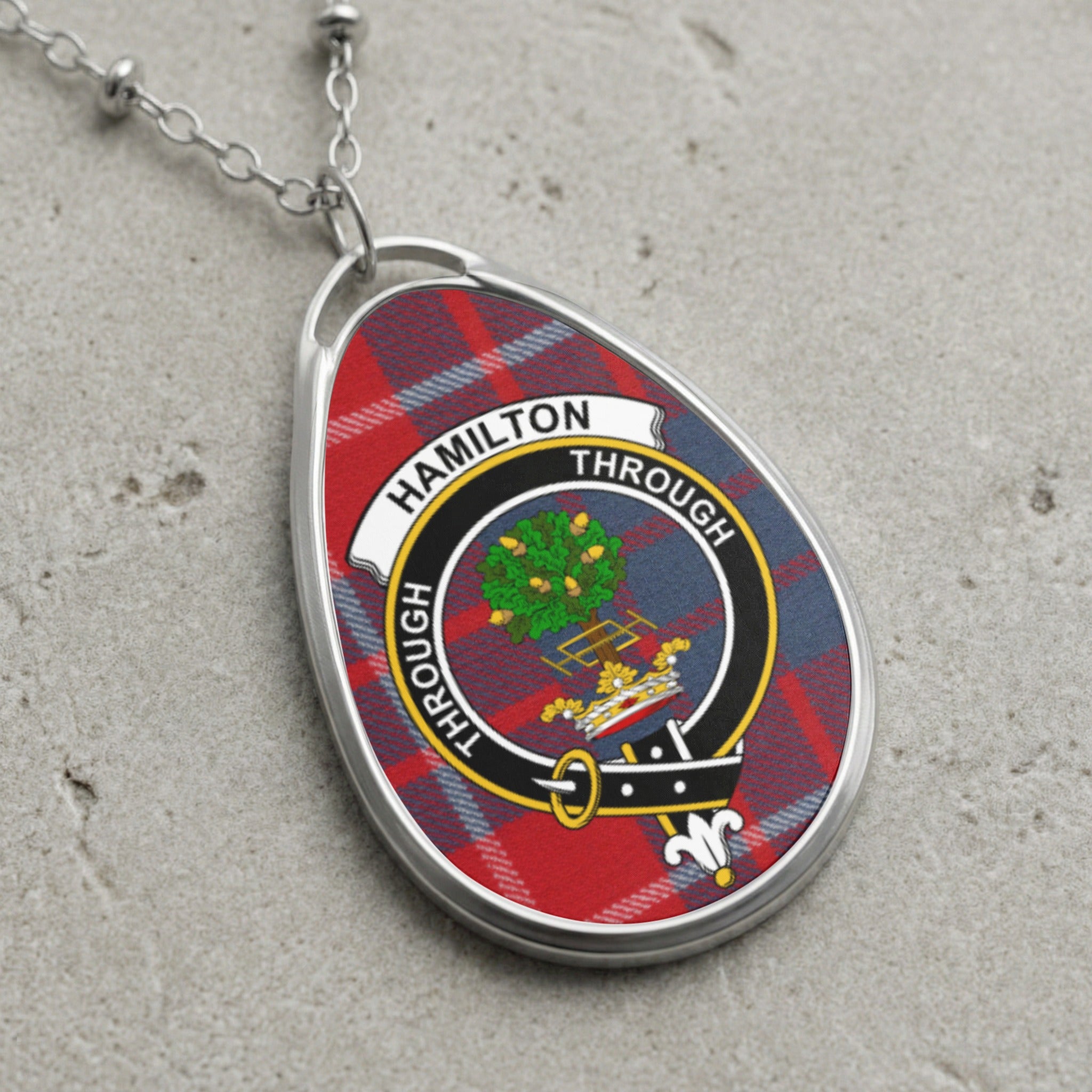 Hamilton clan crest pendant with tartan background on a silver chain.