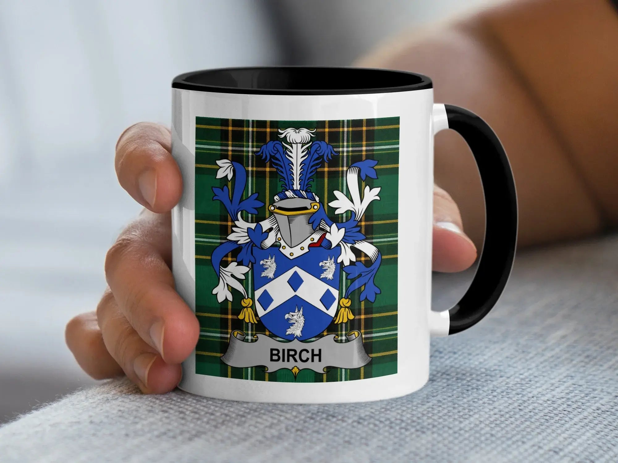 White mug with black rim, featuring a blue and white crest and "BIRCH" text.