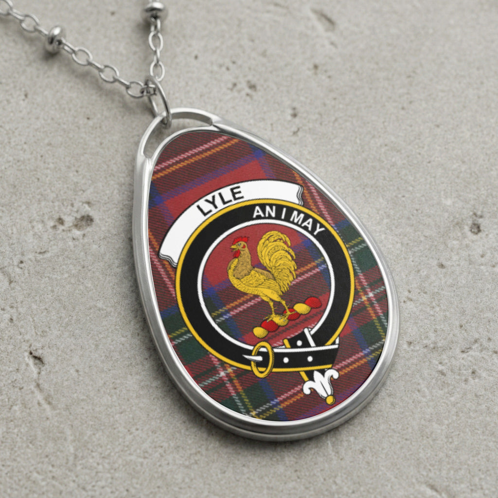 Tartan oval pendant necklace with Lyle family crest and "AN I MAY" motto.
