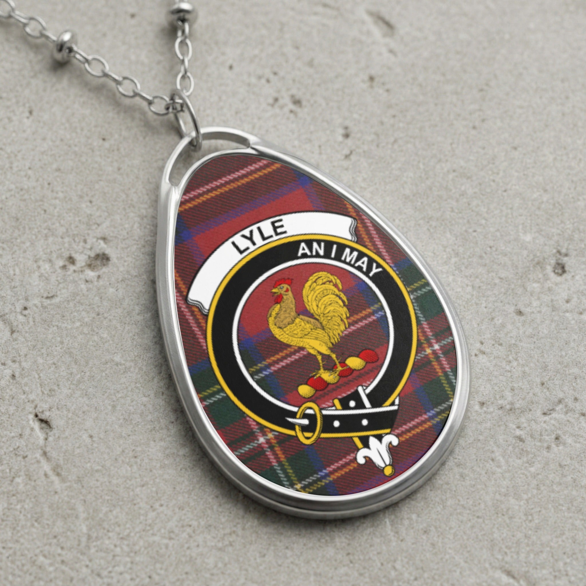 Tartan oval pendant necklace with Lyle family crest and "AN I MAY" motto.
