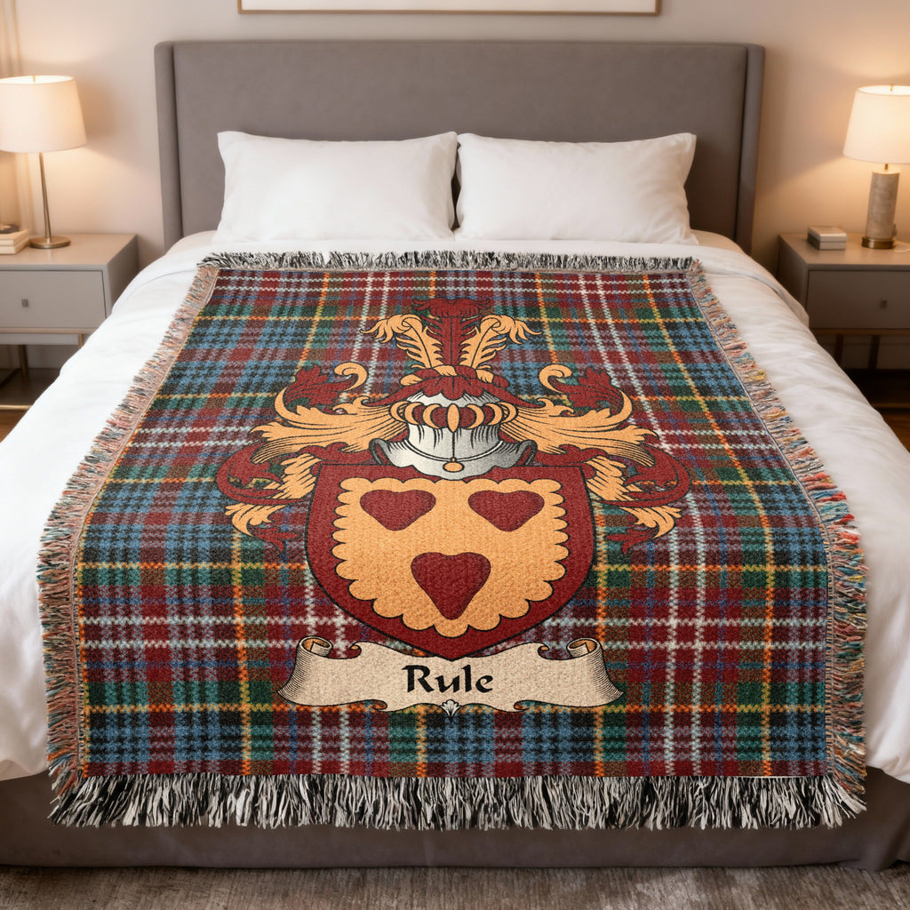 Rule family crest emblem on a Caledonia tartan woven blanket
