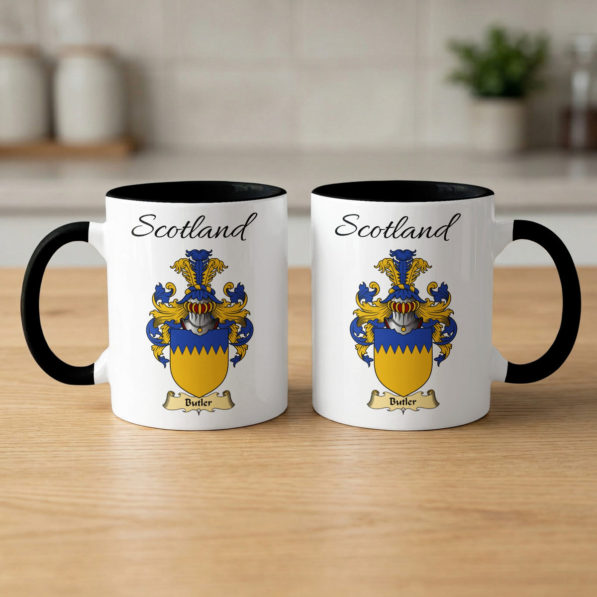 Pair of black-accent Butler mugs showing the double-sided Scottish family shield design on white ceramic.