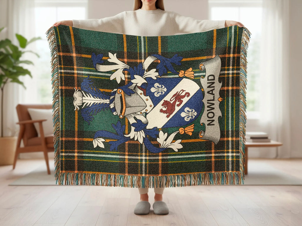 Plaid throw blanket with family crest and "NOWLAND" text.