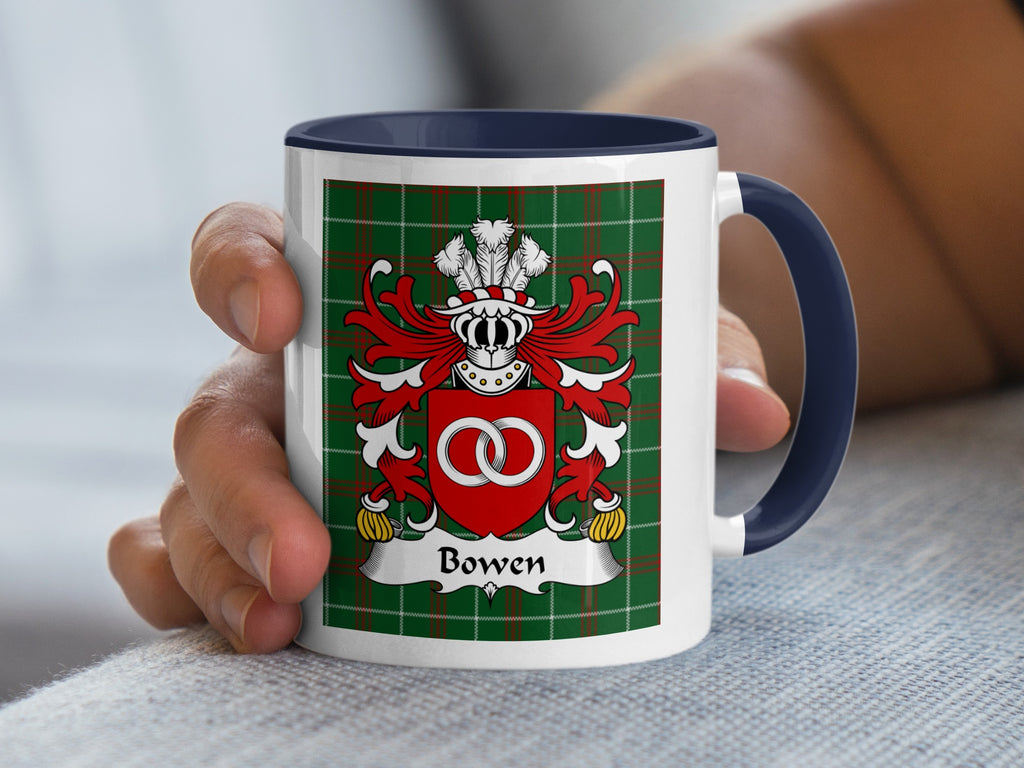 White mug with navy blue handle featuring a green plaid background and the Bowen family crest.
