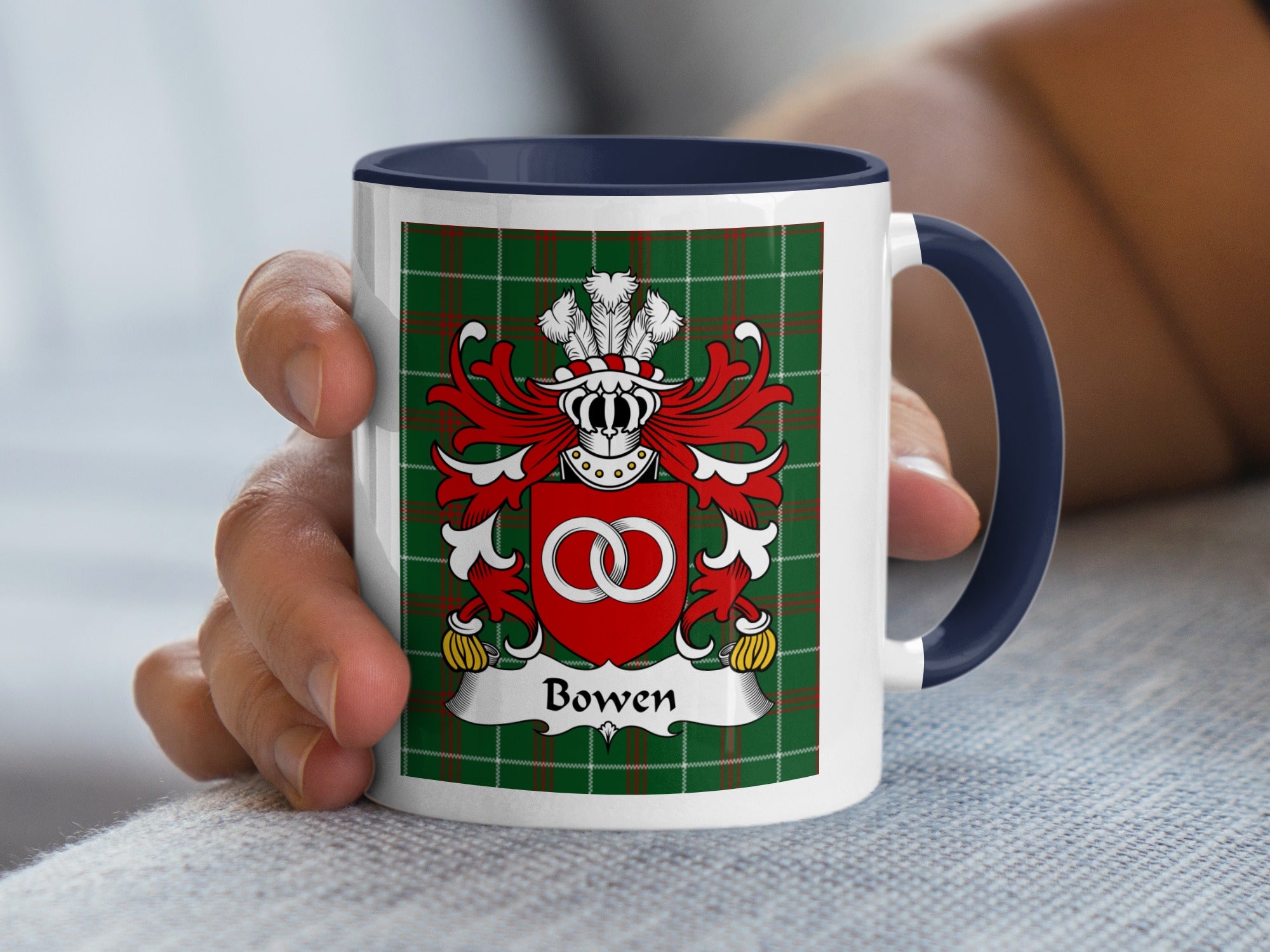 White mug with navy blue handle featuring a green plaid background and the Bowen family crest.
