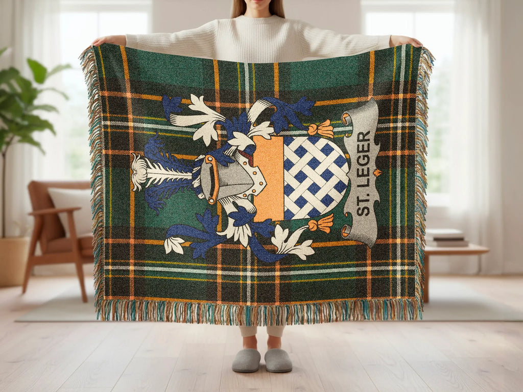 Tartan blanket with St. Leger crest and fringed edges.