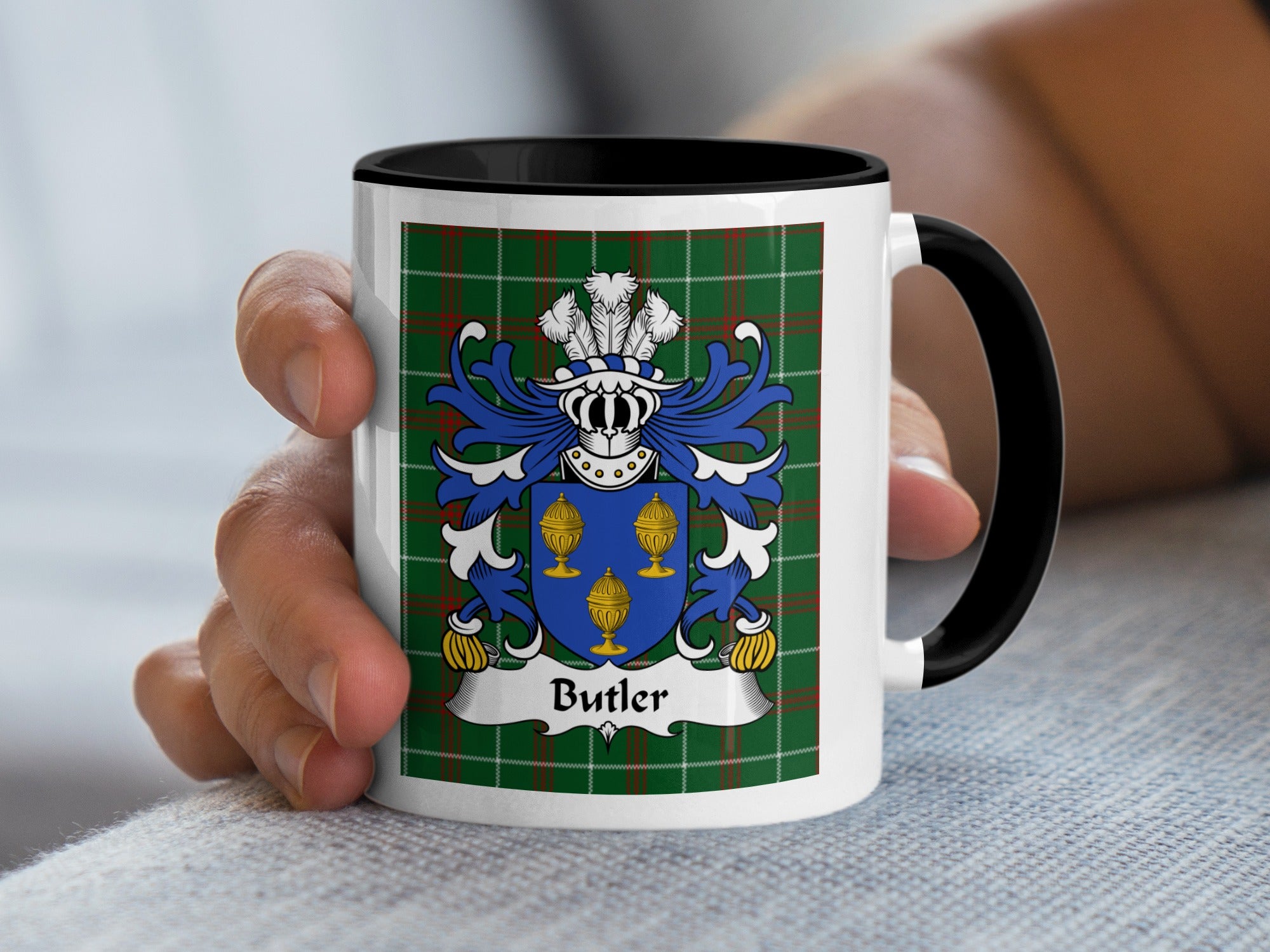 White mug with black handle featuring a tartan background and a family crest with the name "Butler."