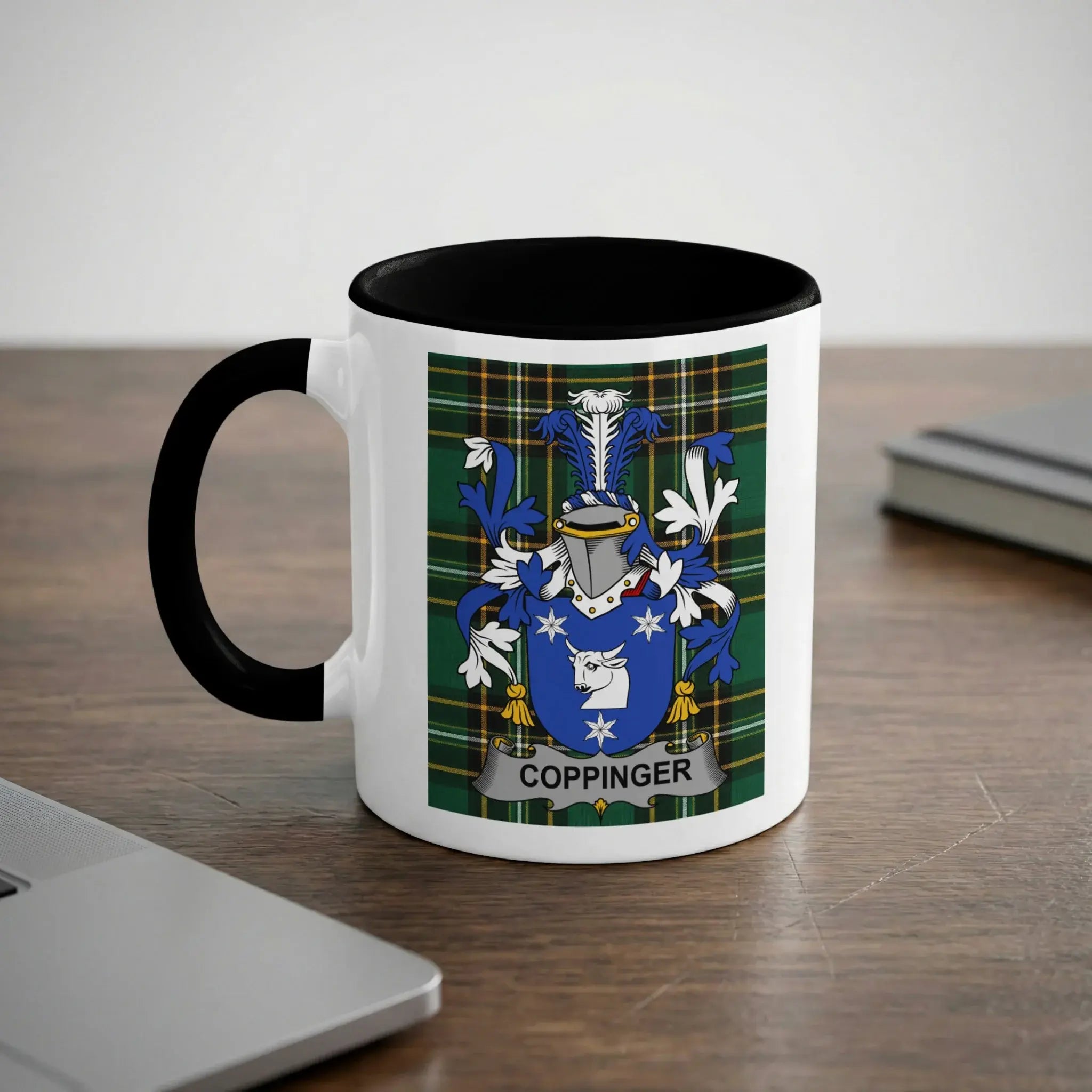 White mug with black rim featuring the Coppinger family crest.