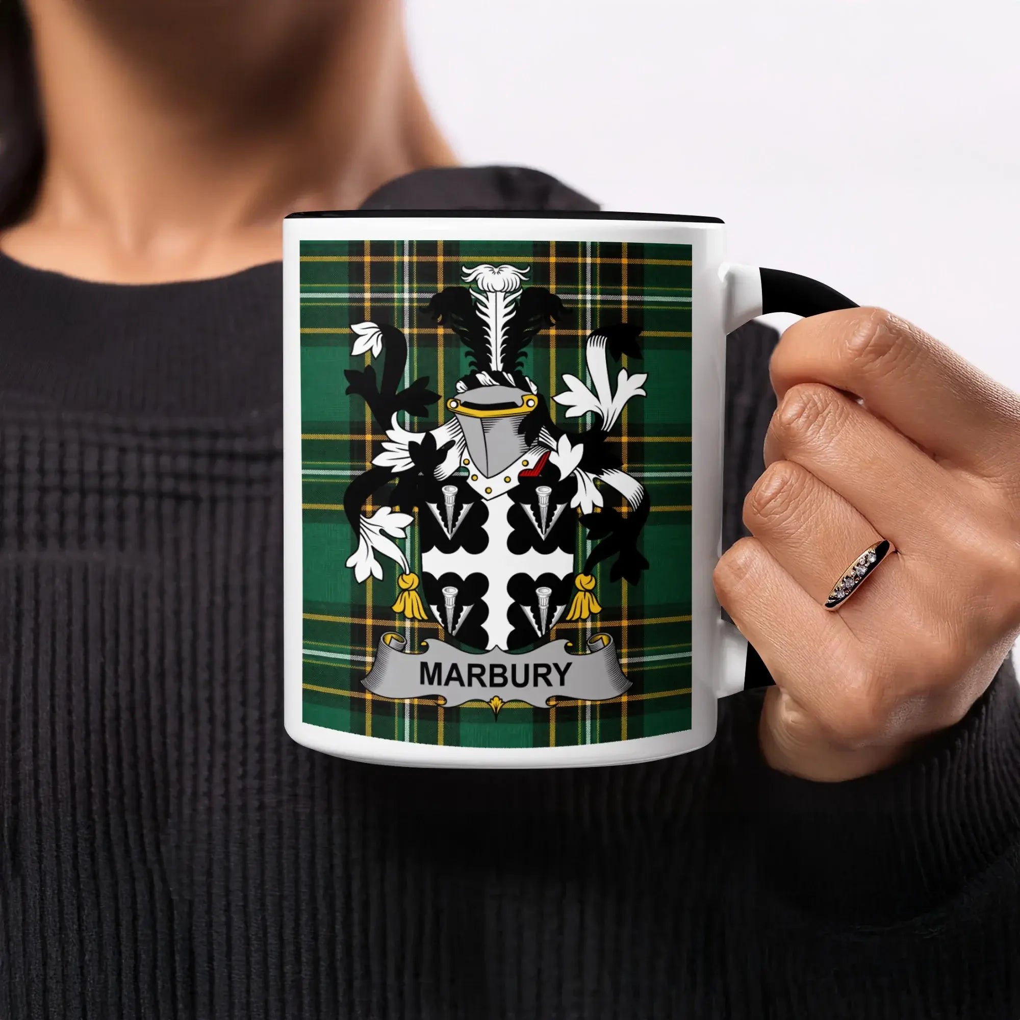 White mug with Marbury family crest on green plaid background.