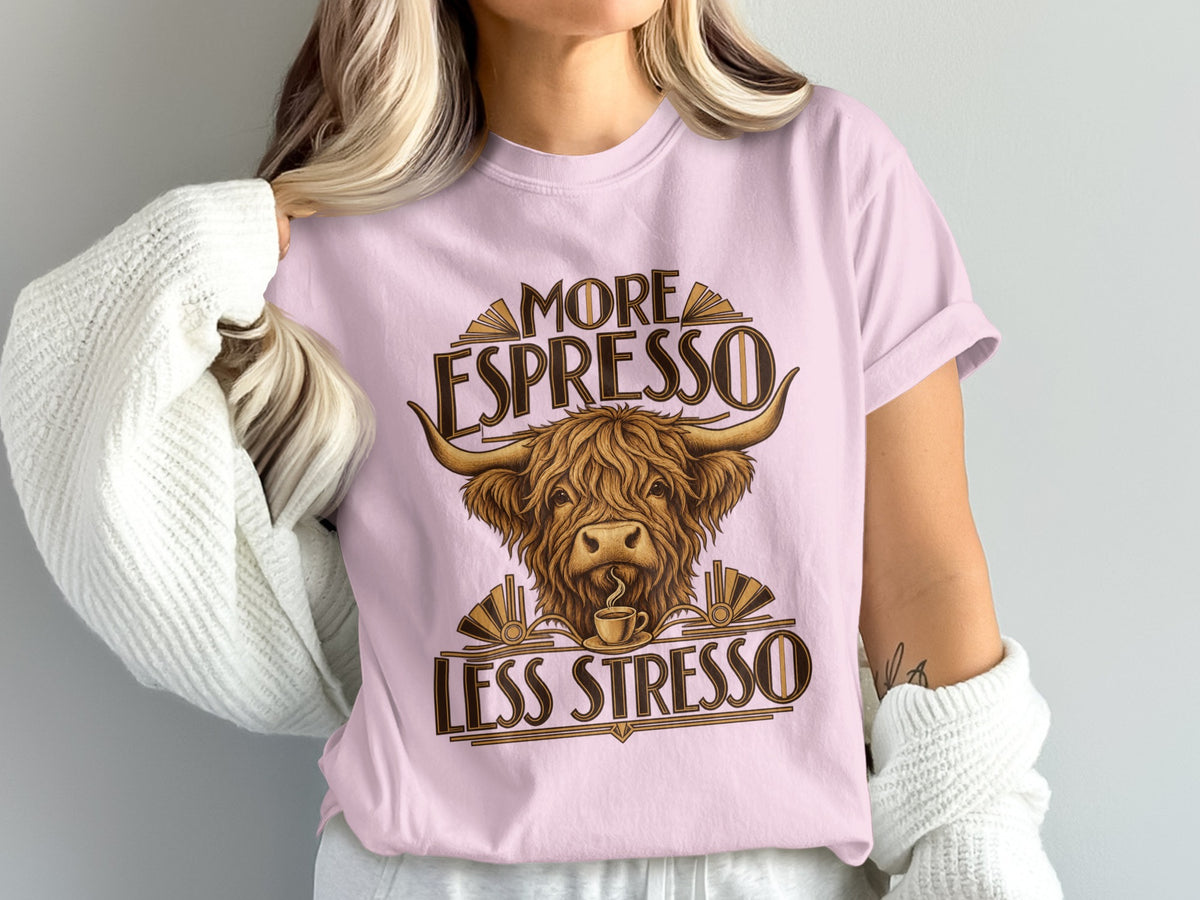 Model wearing the More Espresso, Less Stresso Highland cow Comfort Colors T-shirt in Blossom