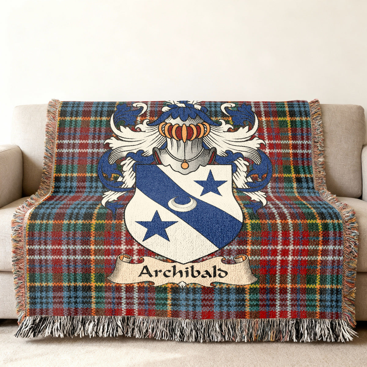 Archibald Scottish family shield woven blanket with Caledonia tartan background on a sofa