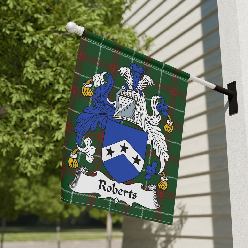 Roberts family crest on a green tartan flag, mounted on a white wall.
