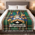 Tartan blanket with Townshend coat of arms displayed on a bed.