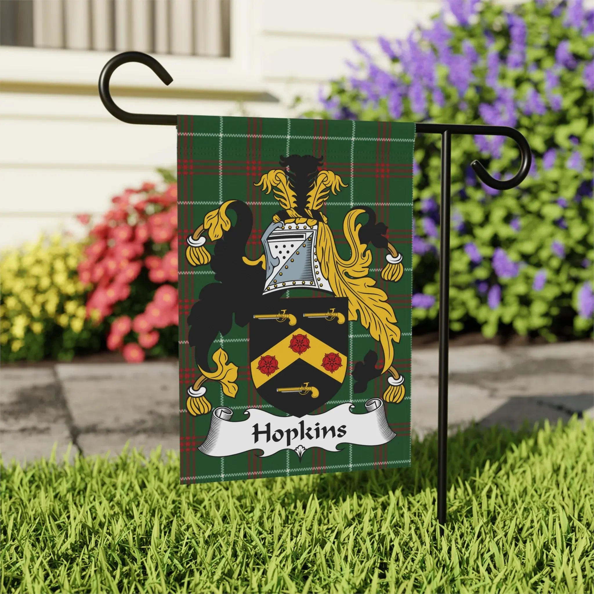 Hopkins family crest on a plaid garden flag.