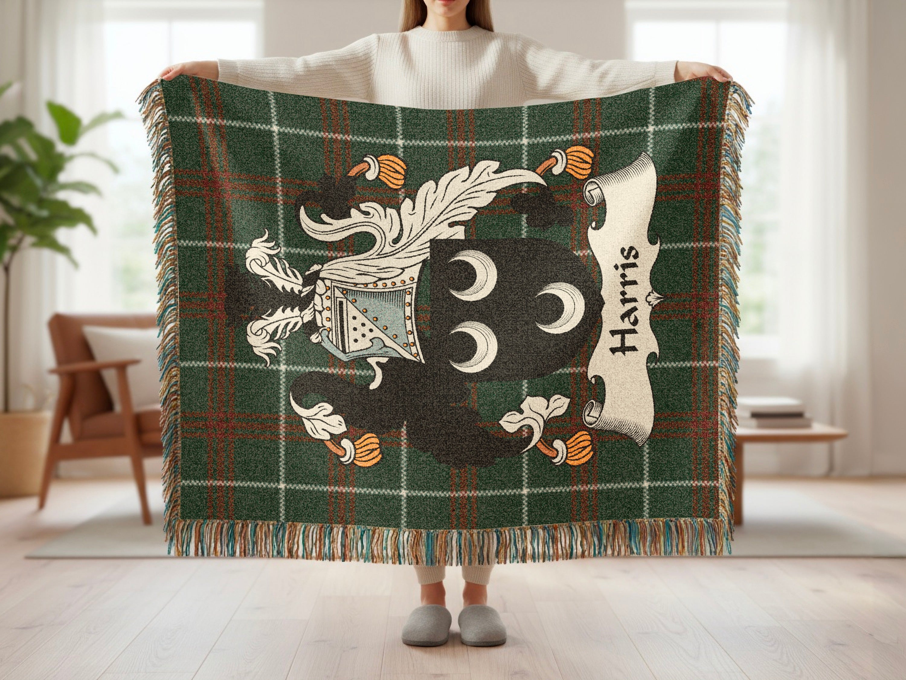 Tapestry blanket with green plaid and the Harris family crest.