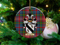 MacTaggart Scottish clan ceramic ornament with family crest on a Caledonia tartan background, hanging on a Christmas tree