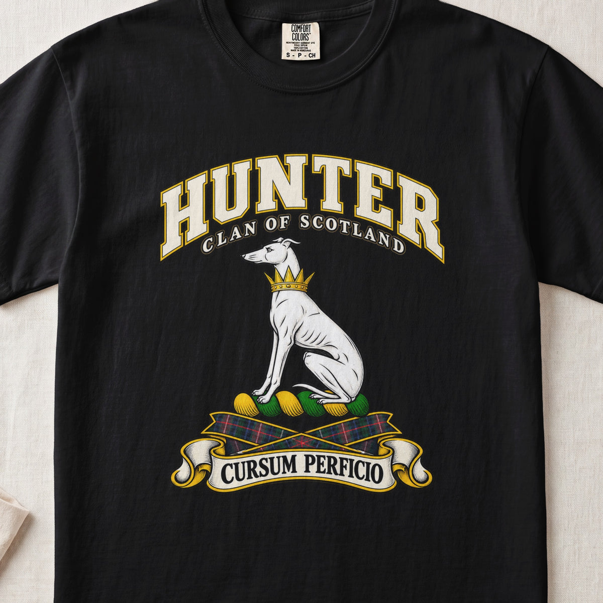 Hunter Scottish clan T-shirt in Black, front view with a seated white hound with a golden collar and motto banner.