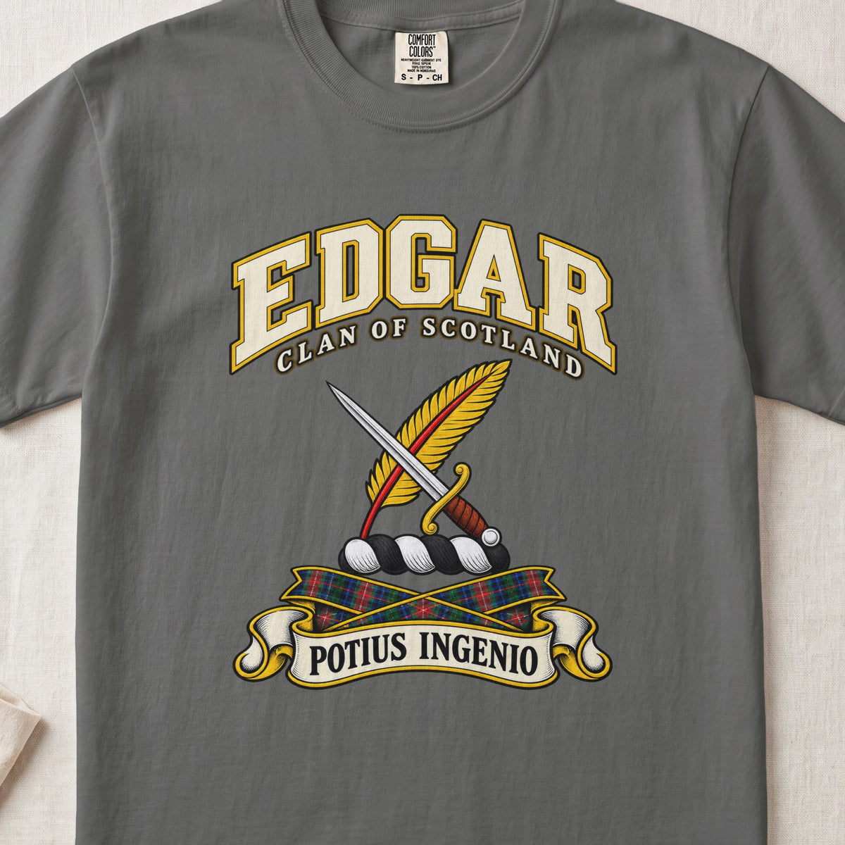 Edgar Scottish clan T-shirt in Pepper, front view with a dagger crossed with a gold feather and motto banner.
