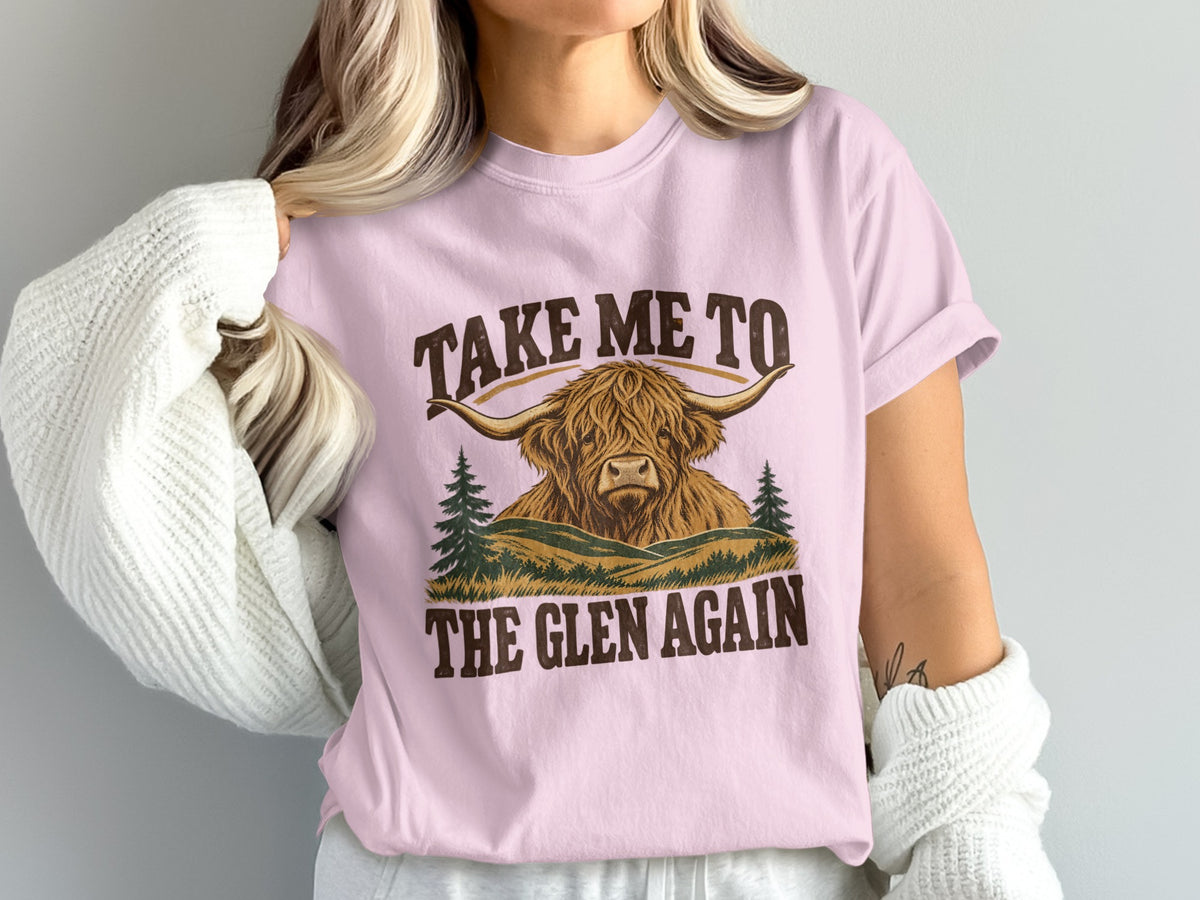 Model wearing the Take Me to the Glen Again Highland cow Comfort Colors T-shirt in Blossom