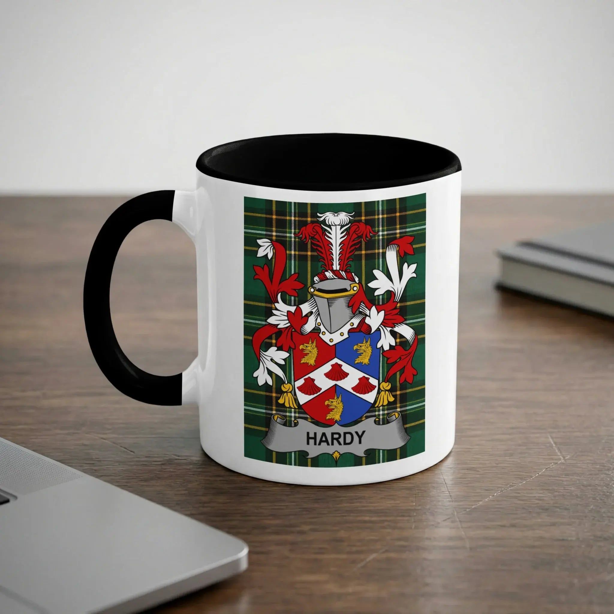 White mug with black rim and handle featuring a colorful coat of arms with "HARDY" text.