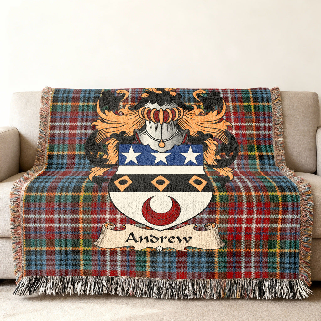 Andrew Scottish family shield woven blanket with Caledonia tartan background on a sofa