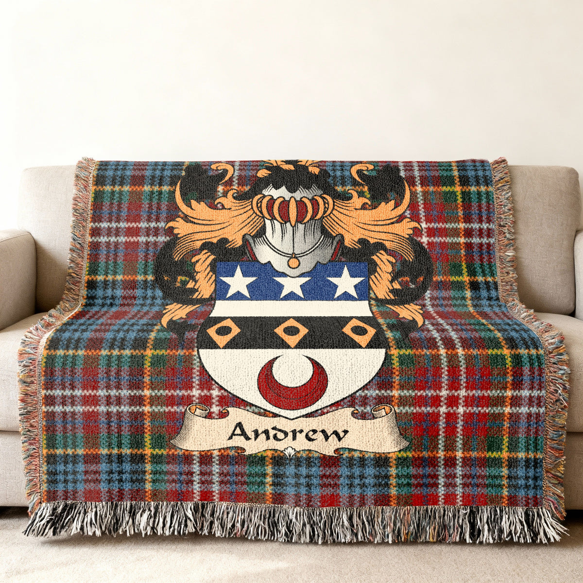 Andrew Scottish family shield woven blanket with Caledonia tartan background on a sofa