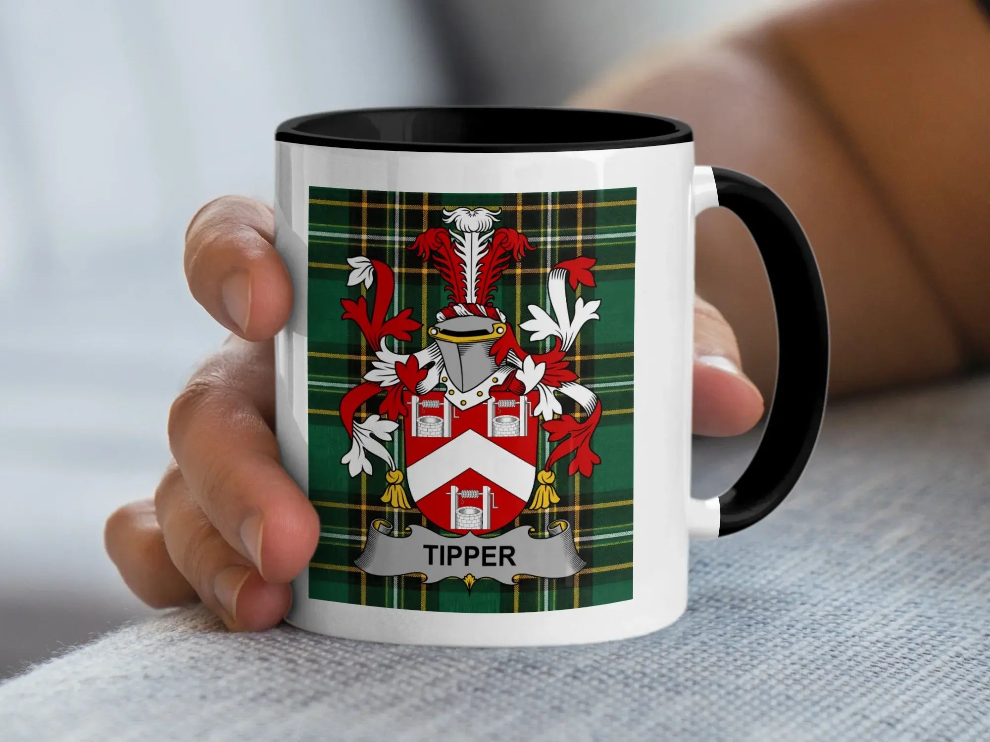 White mug with black rim featuring the Tipper coat of arms on a tartan background.