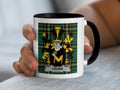 Mug with black rim displaying Croke coat of arms on green tartan background.