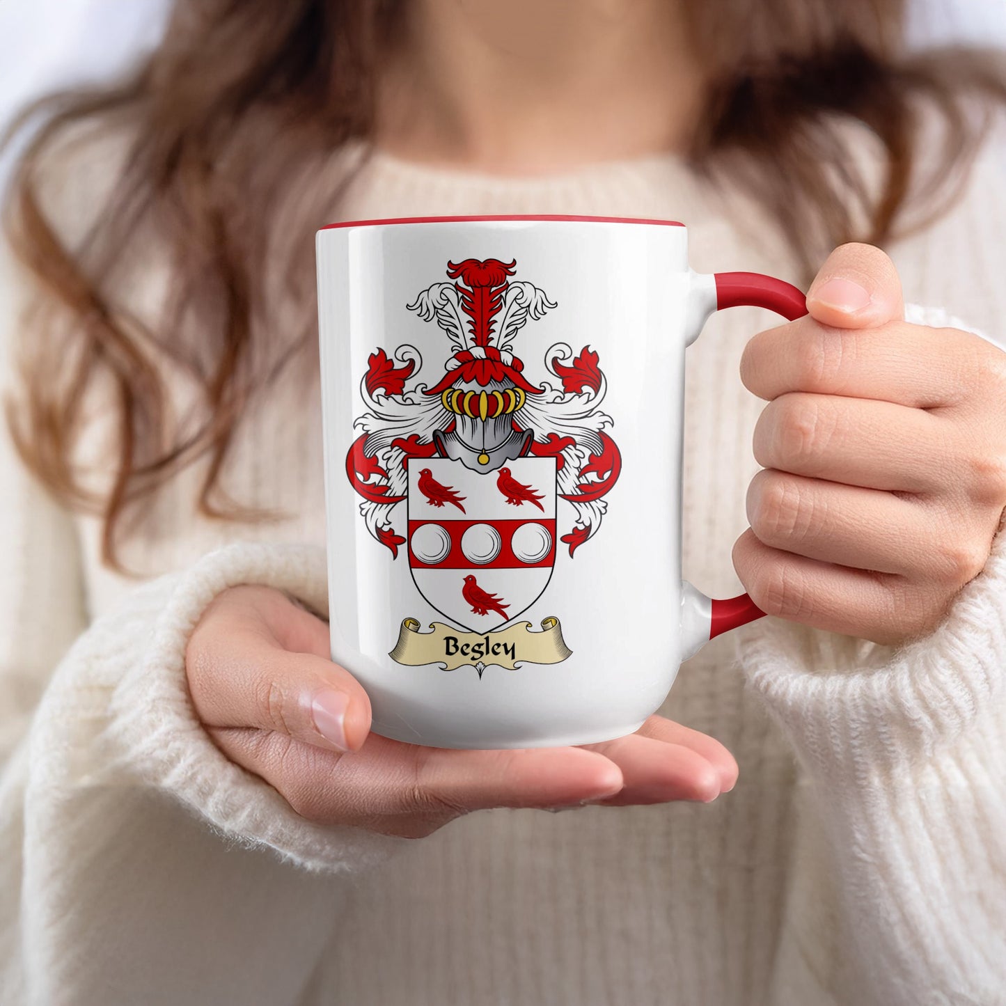 Besley family crest on a white mug with red handle.