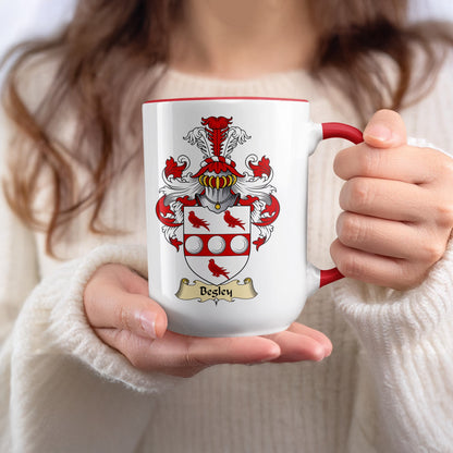 Besley family crest on a white mug with red handle.