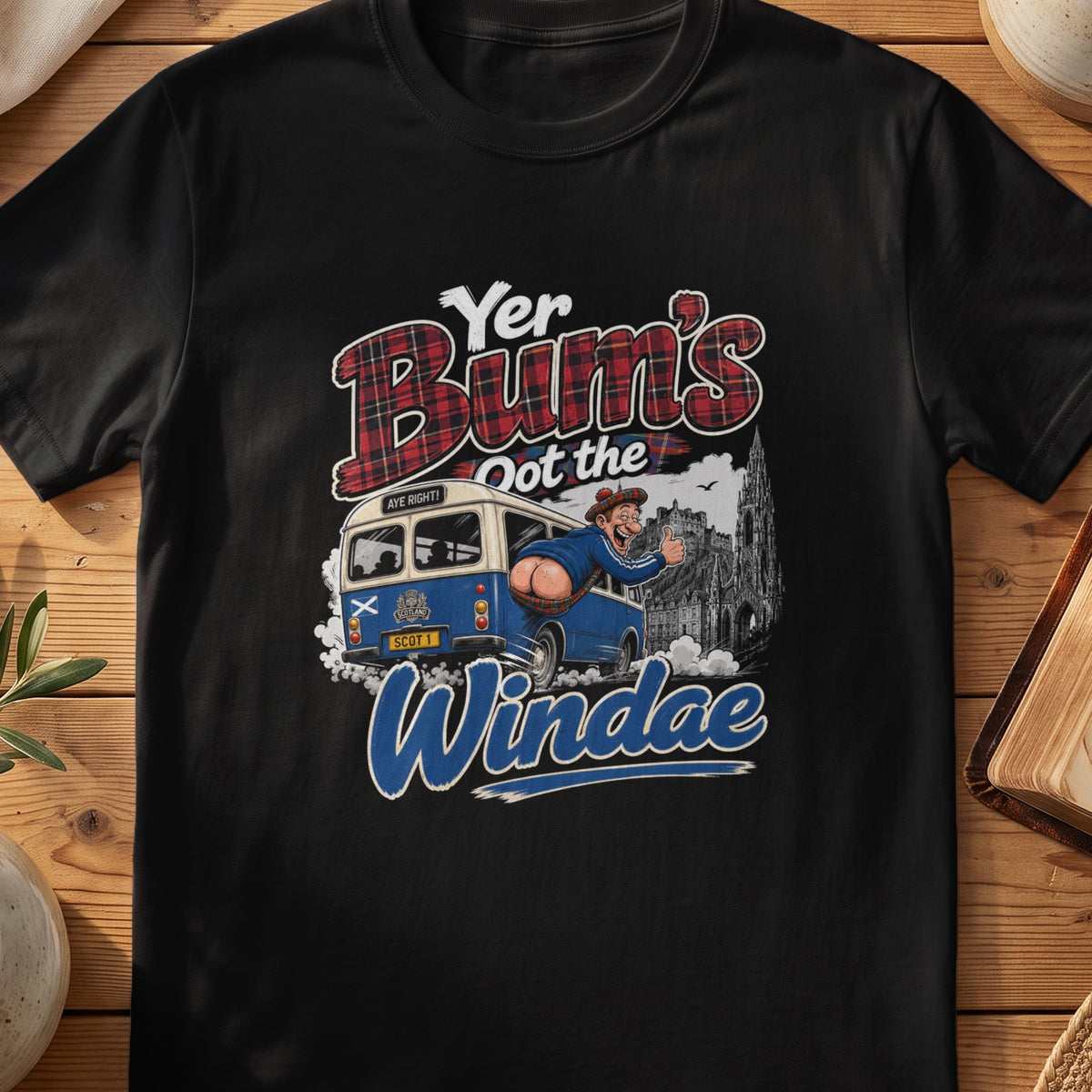 Black Gildan 64000 unisex T-shirt flatlay with Yer Bum's Oot the Windae Scottish graphic design
