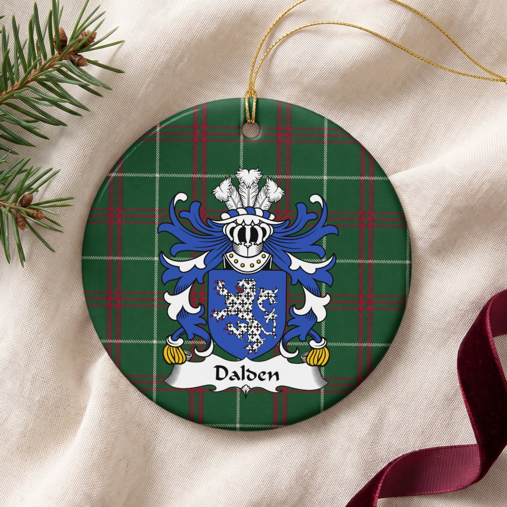 Dalden ornament on cream fabric with gold string, evergreen and burgundy ribbon; a white lion patterned with small black marks on a blue shield.