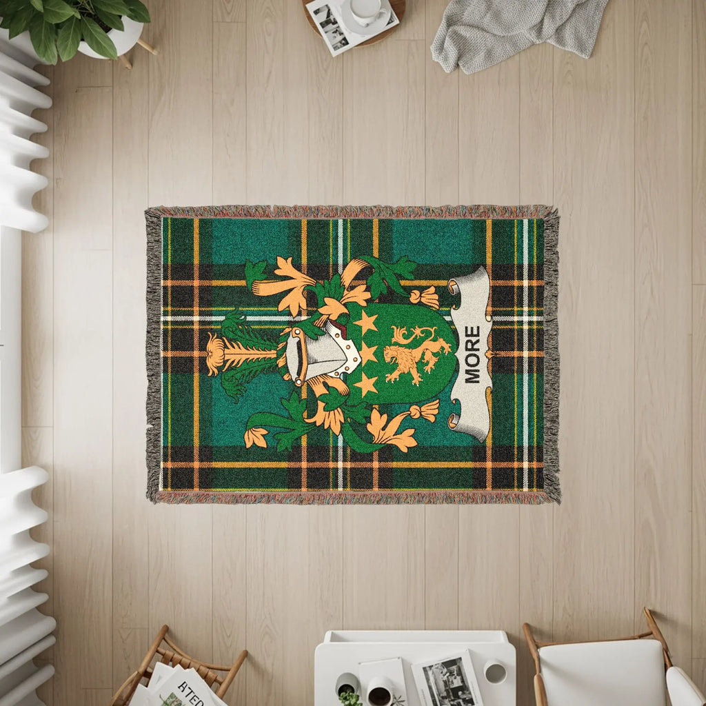 Green tartan throw blanket with More family crest.