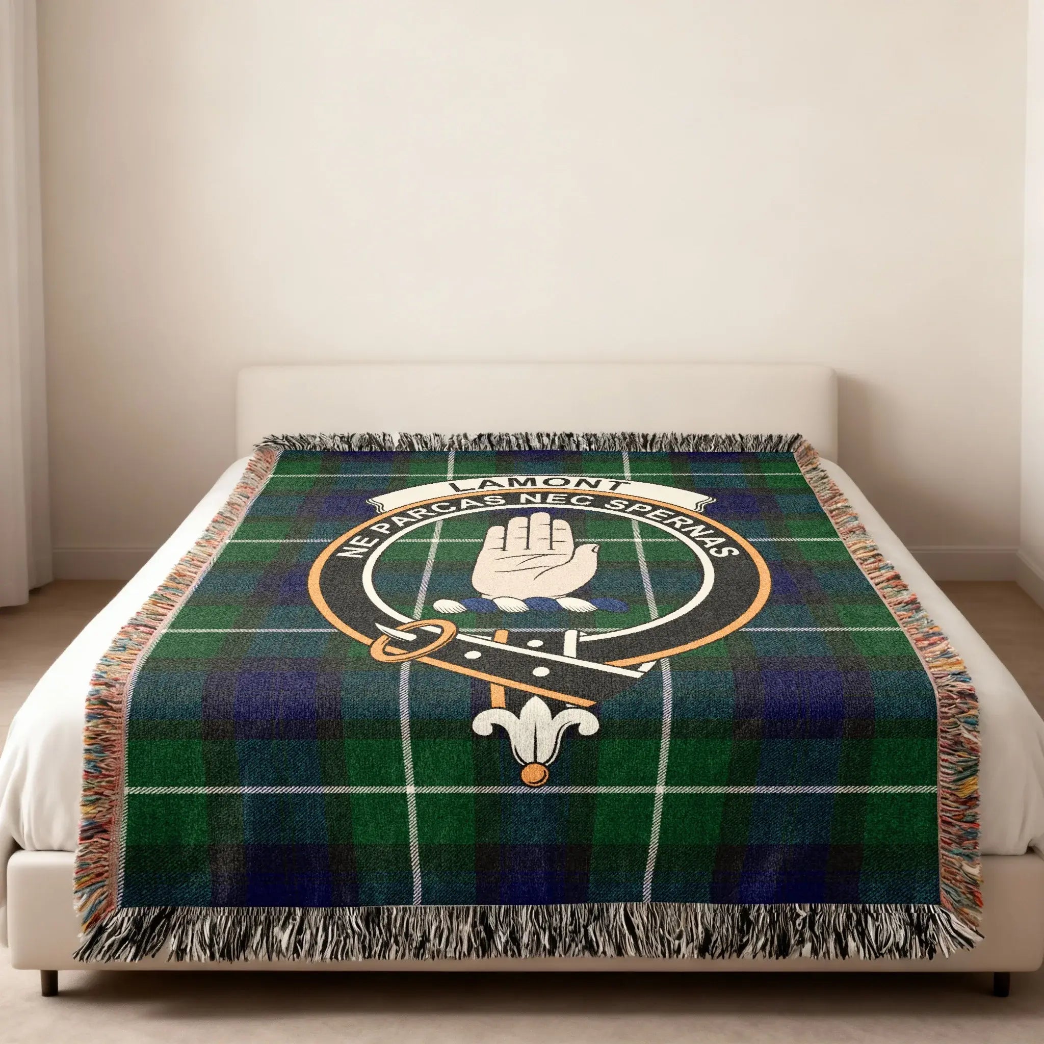 Lamont clan tartan woven blanket with crest design — heraldic design at centre, fringe edge visible