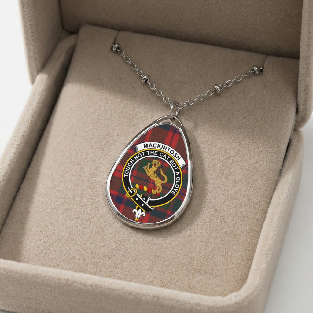 Mackintosh tartan pendant necklace with crest in a jewelry box.