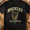 Buckley Irish harp T-shirt in Black, with cream surname lettering, a gold-toned harp, green shamrock and “Irish Heritage” text.