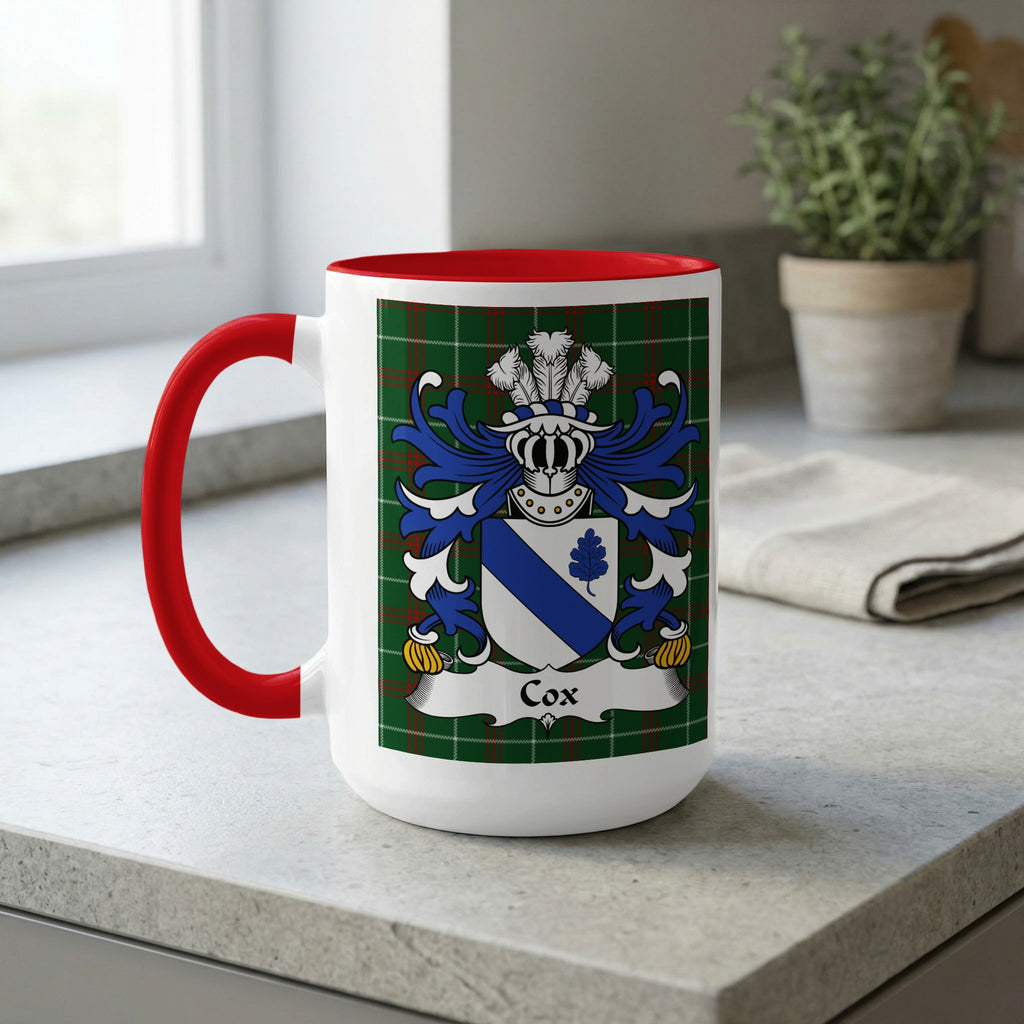 White mug with red handle, featuring the Cox family crest on tartan pattern.