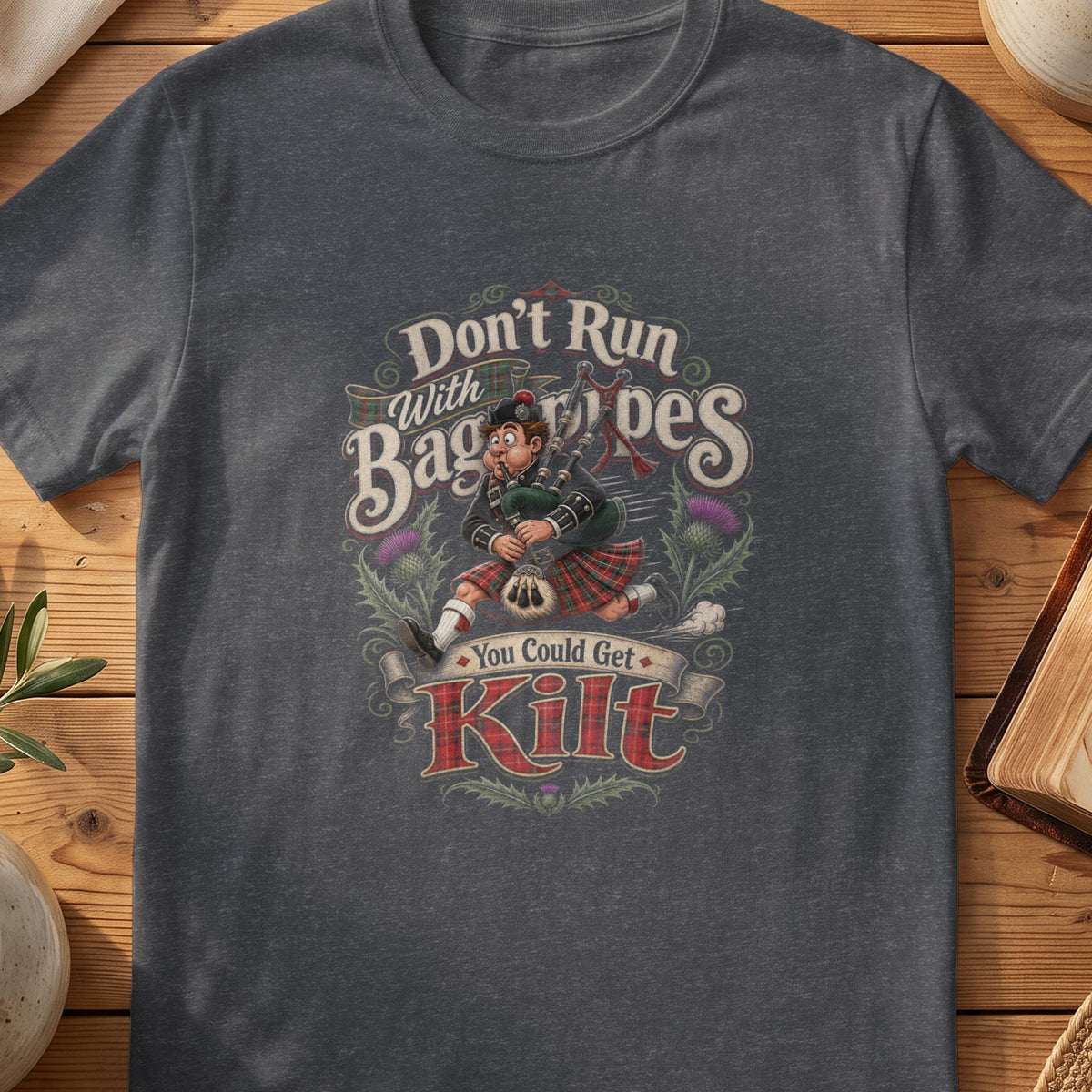 Dark grey Gildan 64000 unisex T-shirt flatlay with Don't Run With Bagpipes You Could Get Kilt Scottish graphic design