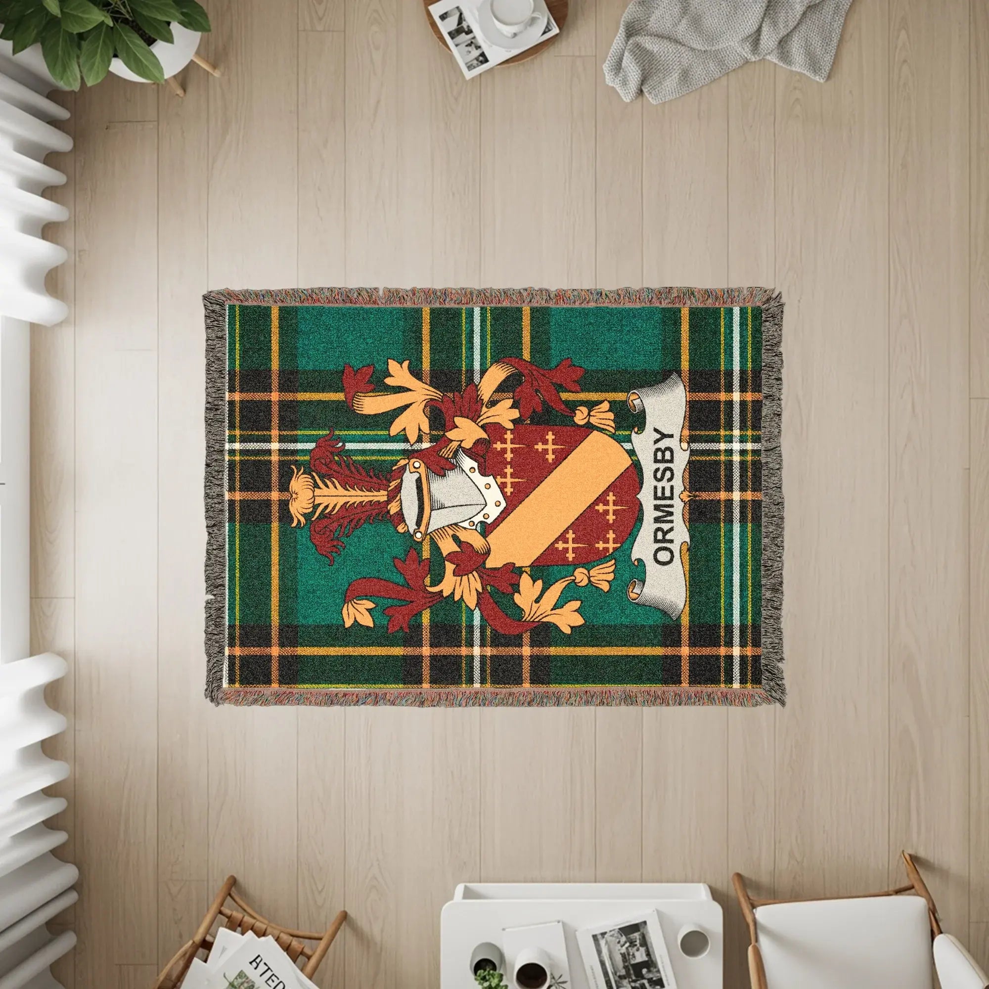 Woven tartan throw with the ORMESBY family crest.