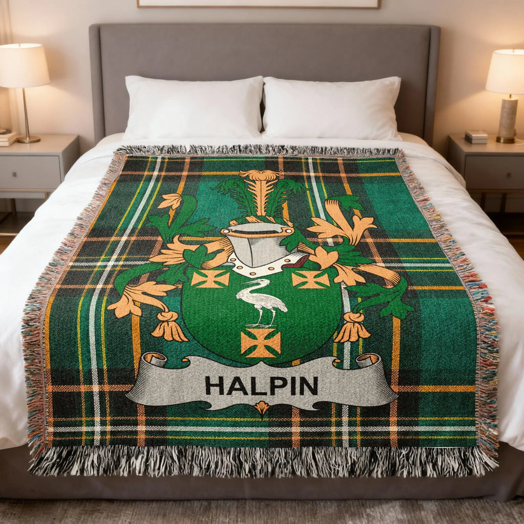 Green tartan throw blanket with a heraldic crest and the name HALPIN.