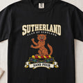 Sutherland graphic T-shirt in Black, front flat lay showing varsity lettering and orange-brown wildcat with raised paws and open mouth.