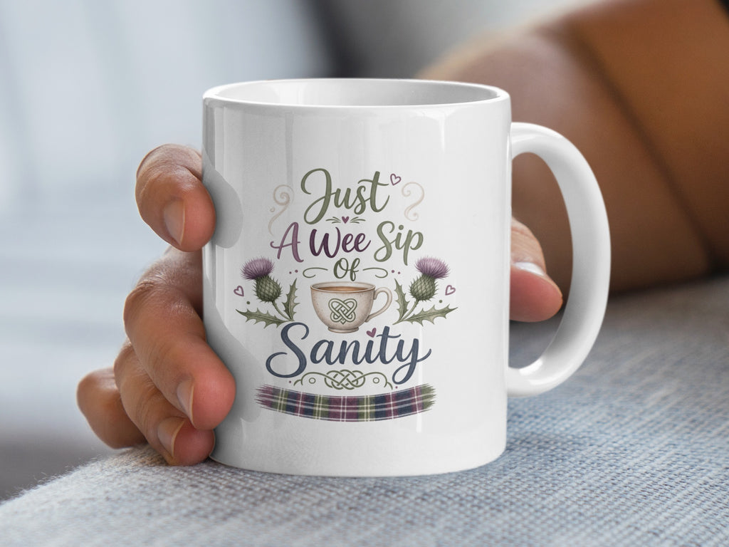 White mug with "Just A Wee Sip Of Sanity" text and Scottish thistle design.